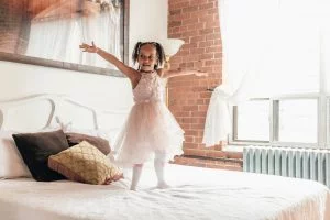 Petite fille qui se lève sur le lit